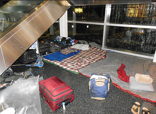 stranded at logan airport camping area under stairs resized 600