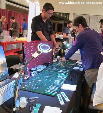 A TAMU researcher finds new products at the 2014 biotech event. 