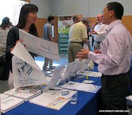 A researcher discuss new products at a past BioReserach Product Faire ™ Event in Ann Arbor, MI.  