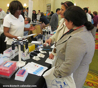 Researchers in Houston discuss new lab equipment with a science supply company sales rep. 