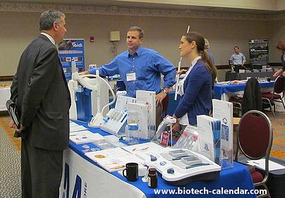 A researchers learns about new products at a past BioResearch Product Faire™ Event. 