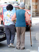 An elderly couple out for a walk. 