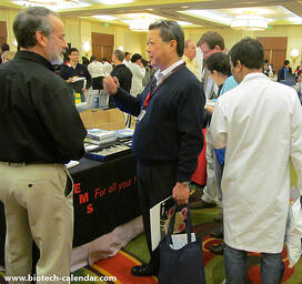 Electron Microscopy Sciences exhibitor discuss the latest labware with intrigued researcher.